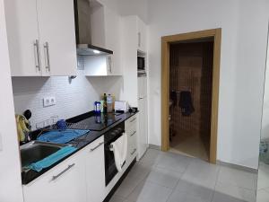 a kitchen with a sink and a counter top at Finisterrae Centro in Finisterre