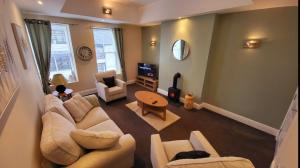 a living room with two couches and a tv at Hicks Central - Sleeps 2 in Whitehaven