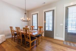a dining room with a wooden table and chairs at 408B The Lynnhaven House Spacious 4 BR Townhouse Walking Distance to the Beach and Boardwalk in Virginia Beach