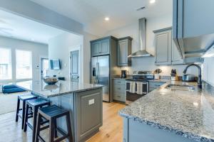 a kitchen with blue cabinets and a counter top at 408B The Lynnhaven House Spacious 4 BR Townhouse Walking Distance to the Beach and Boardwalk in Virginia Beach
