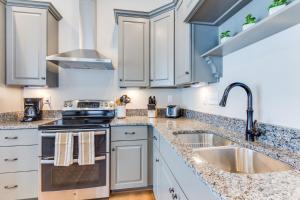 a kitchen with white cabinets and a sink at 408B The Lynnhaven House Spacious 4 BR Townhouse Walking Distance to the Beach and Boardwalk in Virginia Beach
