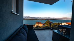 a balcony with a view of a body of water at Trogir Padre Dante FREE PARKING and STARLINK High speed internet in Trogir