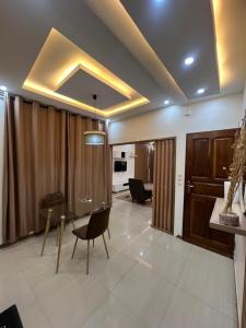 a dining room with a glass table and chairs at CATU Colors and Comfort, A Choice of Studios in Dakar in Dakar +45 photos