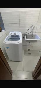a bathroom with a toilet and a sink at Apto Novo Jardim Rosinha 04 in Sao Paulo