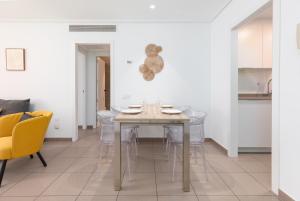 a dining room with a table and chairs at ApartUP Patacona Iconic I in Valencia