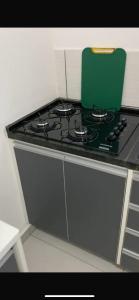 a stove top with a green pot on top of it at Apto Novo Jardim Rosinha 04 in Sao Paulo +15 photos