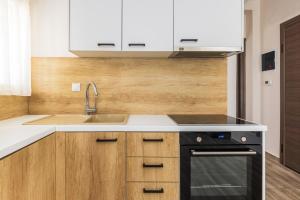 a kitchen with a sink and a stove at Tropical & Faces by Nest in Thessaloniki