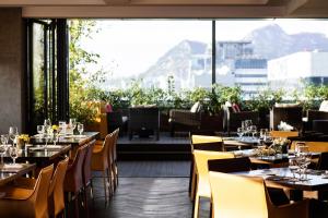 a restaurant with tables and chairs and a large window at Fraser Place Central Seoul in Seoul