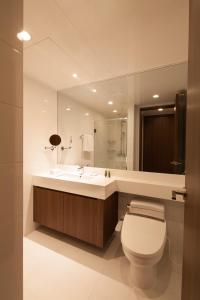 a bathroom with a sink and a toilet and a mirror at Fraser Place Central Seoul in Seoul
