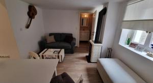 a living room with a couch and a table at Apartman Manuela in Pag