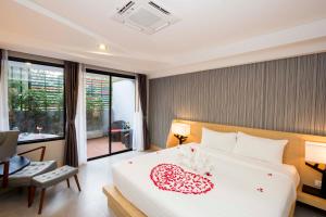 Voodi või voodid majutusasutuse Apple A Day Resort Krabi-SHA Extra Plus toas