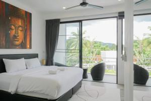 a bedroom with a bed and a large window at The Blue Lotus in Mae Nam +157 photos