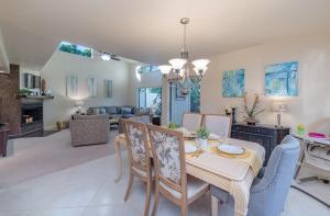 a dining room and living room with a table and chairs at Eagles Nest Florida in Naples