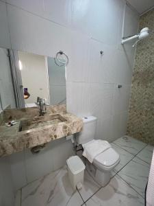 a bathroom with a sink and a toilet at Pousada Velho Brito in Piranhas