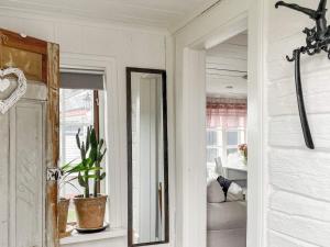 a hallway with a mirror and a potted plant at 4 star holiday home in Märsta in Märsta