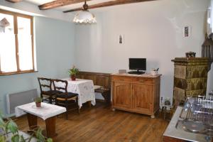 a living room with a table and a computer on a desk at Gîtes Du Stekala in Kaysersberg
