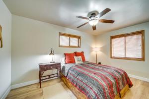 a bedroom with a bed and a ceiling fan at Strawberry Hideaway in the Pines with Hot Tub! in Pine