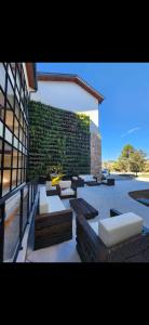 a building with white couches and a wall at Wanderlust Experience Hotel, BW Signature Collection in Campos do Jordão +17 photos