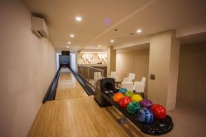 a bowling alley with pins and balls on the lanes at Hotel Slamený Dom & SPA in Košice
