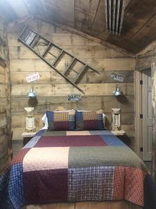 a bedroom with a bed in a wooden wall at Harper Tree Top in Rising Fawn