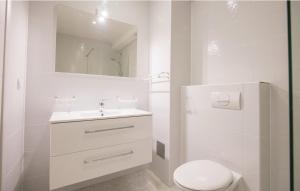 a white bathroom with a toilet and a sink at Villa Sucuraj in Sućuraj +86 photos