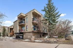 an apartment building with a tree in front of it at Winter Getaway in the Rockies in Avon