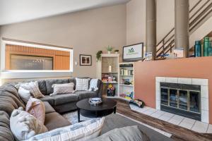 a living room with a couch and a fireplace at Family Vacation Home Hot Tub Pool Free Village Bus in Vail