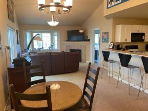 a kitchen and living room with a table and chairs at Edwards Mountain Chic On River Pool and Hot Tubs in Edwards
