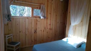 a bedroom with a bed and a window in it at Casa Oceania del Polonio in Rincón de los Oliveras