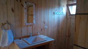 a bathroom with a sink and a mirror at Casa Oceania del Polonio in Rincón de los Oliveras