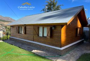 a small wooden house with a metal roof at Cabaña Lucio in Esquel