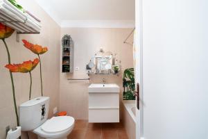 a bathroom with a toilet and a sink and a tub at Casa Paraiso - stylish gateway in Carvoeiro +40 photos