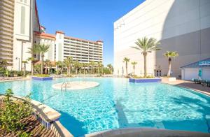 a large swimming pool in front of a building at BeachFrnt 2 Hottub 5 Pools Jet Ski in Panama City Beach