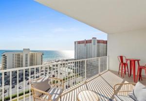 a balcony with chairs and a view of the ocean at BeachFrnt 2 Hottub 5 Pools Jet Ski in Panama City Beach