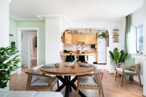 a kitchen and dining room with a wooden table at Casa Paraiso - stylish gateway in Carvoeiro