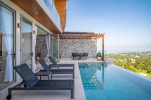a house with a swimming pool and a patio at Villa Lotus Bay Luxurious Retreat In Koh Samui in Koh Samui 