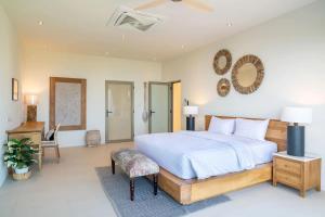 a bedroom with a large white bed and a desk at Villa Lotus Bay Luxurious Retreat In Koh Samui in Koh Samui  +25 photos