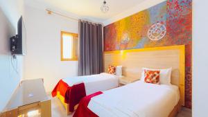 Postel nebo postele na pokoji v ubytování Fyndy Hotel Dakhla