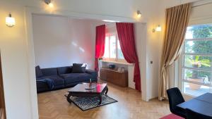 a living room with a couch and a table at Beach Villa Apartment on top location, with pool, sea view and exotic garden in Split