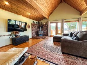 a living room with a couch and a fireplace at Olympic Oasis Tranquil Retreat Near Dungeness Wildlife Refuge Hot Tub in Sequim