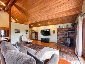 a living room with a couch and a fireplace at Olympic Oasis Tranquil Retreat Near Dungeness Wildlife Refuge Hot Tub in Sequim