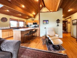 a living room with a couch and a kitchen at Olympic Oasis Tranquil Retreat Near Dungeness Wildlife Refuge Hot Tub in Sequim +19 photos