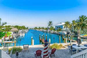 a pool at a resort with tables and chairs at Ocean Oasis III in Key Colony Beach