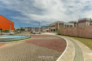 a brick walk way in a city with buildings at Apto 450m da Praia em Cond. c/ Piscina VAR0302 in Cururupe