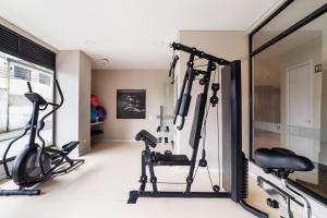 a gym with two treadmills and two exercise bikes at Apartment in the international center of Bogotá in Bogotá
