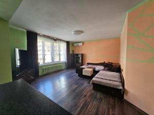 a room with two beds and a table in it at Apartment Lozenets in Sofia