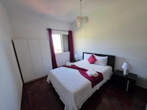 a bedroom with a large bed with pink pillows at Silva House in Ribeira Brava +15 photos