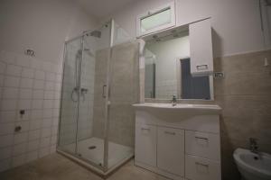 a bathroom with a shower and a sink and a mirror at Hostel Bosmi Bed&Language Liguria in Sori +19 photos