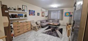 a living room with a couch and a table at Zen Lodge, with private parking in Sofia