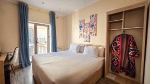 a bedroom with a large bed and a window at Hotel Bankir Khiva in Khiva